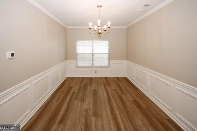 unfurnished dining area with an inviting chandelier, crown molding, and dark hardwood / wood-style floors