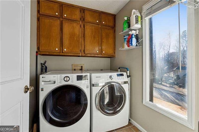 washroom with washer and clothes dryer, tile patterned flooring, cabinet space, and baseboards