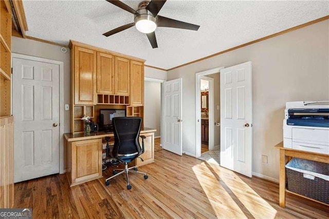 home office with a textured ceiling, ceiling fan, wood finished floors, and crown molding