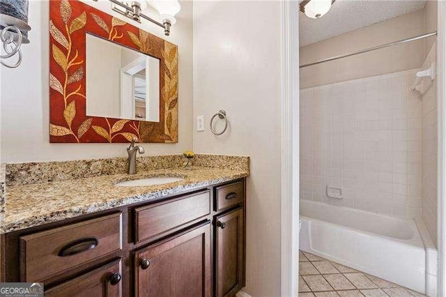 full bathroom with a textured ceiling, bathtub / shower combination, vanity, and tile patterned floors