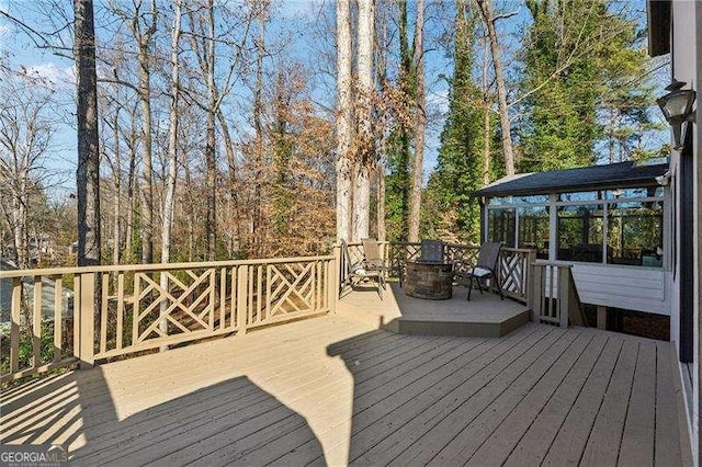 wooden deck with a sunroom