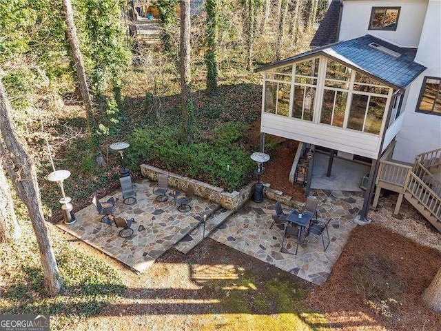 exterior space featuring a sunroom and a patio