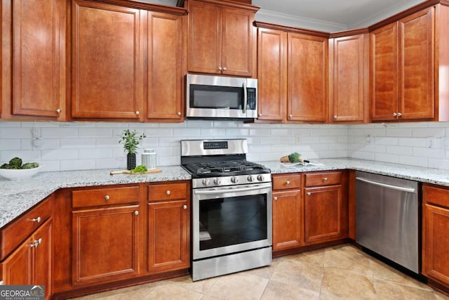 kitchen with light tile patterned floors, crown molding, appliances with stainless steel finishes, backsplash, and light stone counters