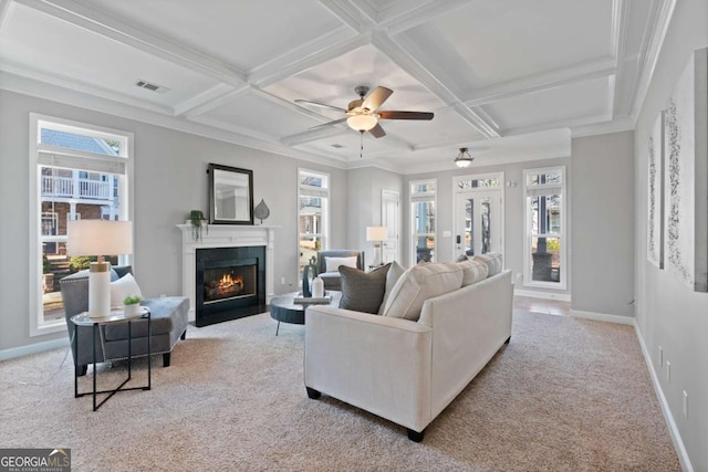 carpeted living room with plenty of natural light, coffered ceiling, and beam ceiling