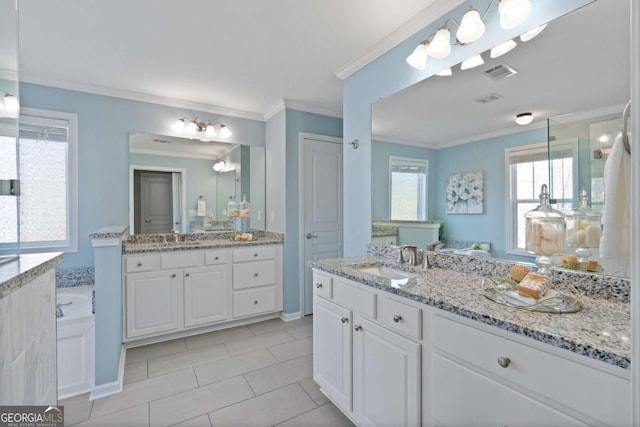 bathroom with crown molding, tile patterned floors, vanity, and a bathtub