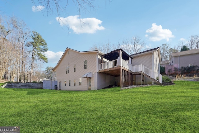 rear view of house featuring a wooden deck and a yard