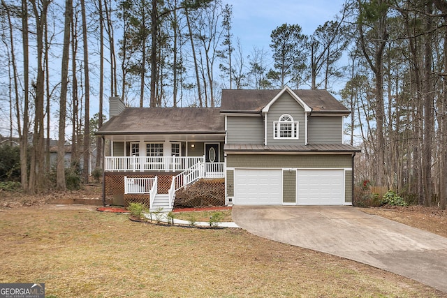 tri-level home with a chimney, a porch, a garage, driveway, and stairs