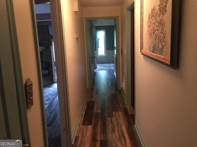 corridor with dark hardwood / wood-style floors