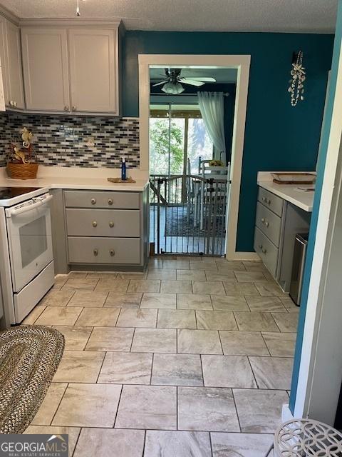 kitchen featuring ceiling fan, gray cabinets, and white range with electric stovetop