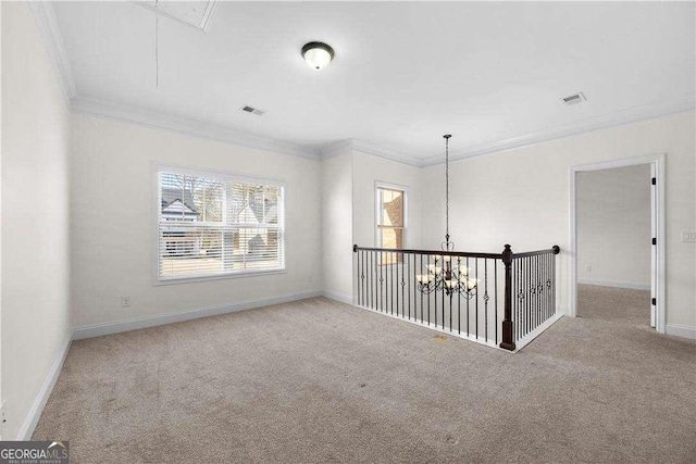 carpeted empty room with ornamental molding and a notable chandelier