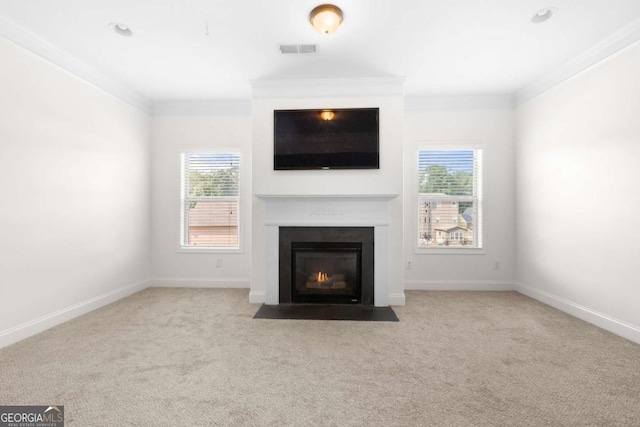 unfurnished living room featuring crown molding and light colored carpet