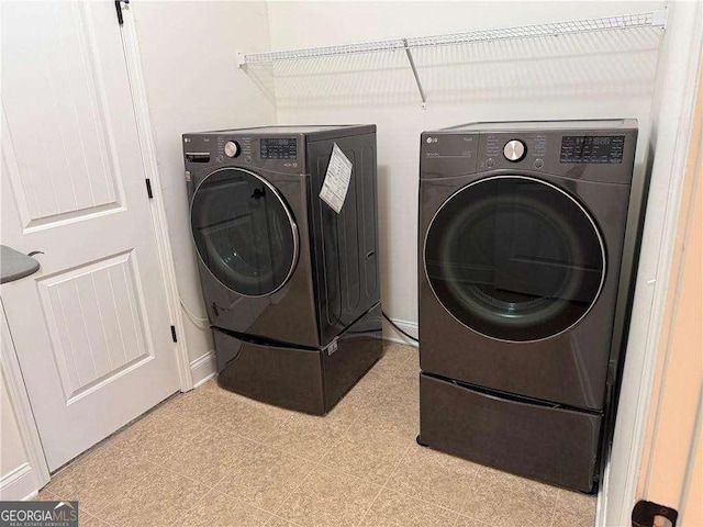 laundry room featuring separate washer and dryer