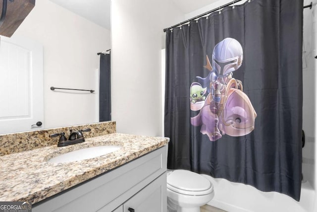 full bathroom with vanity, shower / bath combo, and toilet