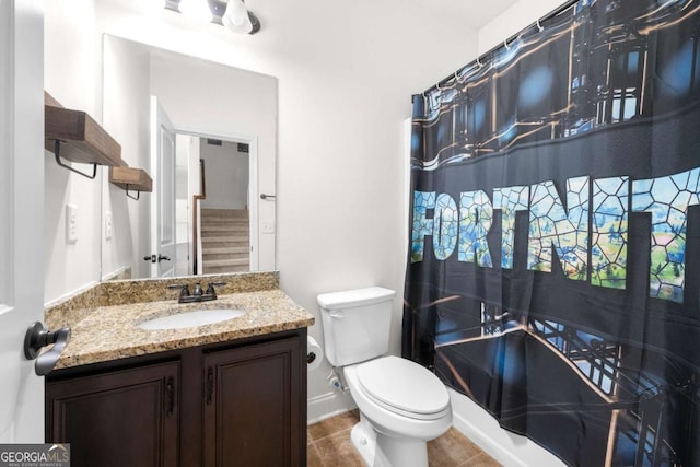 bathroom with vanity, toilet, and tile patterned flooring