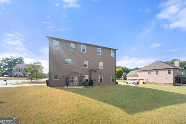 rear view of house featuring a yard