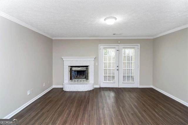 unfurnished living room featuring ornamental molding, a fireplace, dark hardwood / wood-style flooring, and french doors