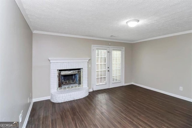 unfurnished living room with ornamental molding, dark wood-type flooring, a fireplace, and french doors