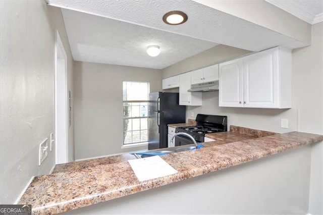 kitchen featuring white cabinets, sink, a textured ceiling, and black appliances