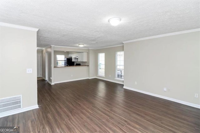 unfurnished living room featuring ornamental molding, dark hardwood / wood-style floors, and a textured ceiling