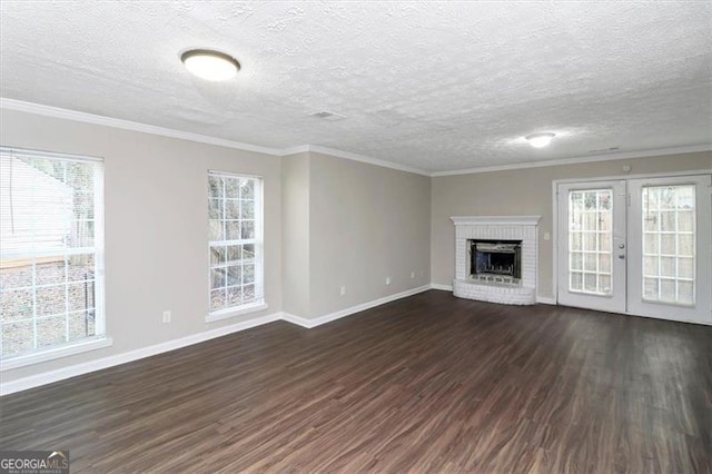 unfurnished living room with plenty of natural light, a fireplace, and dark hardwood / wood-style flooring