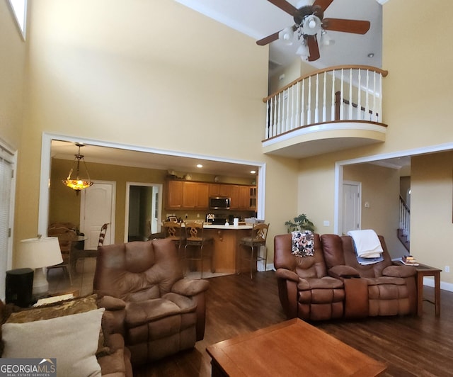 living room with dark hardwood / wood-style floors and ceiling fan