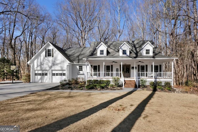 cape cod house with a porch, a garage, a front yard, and ceiling fan