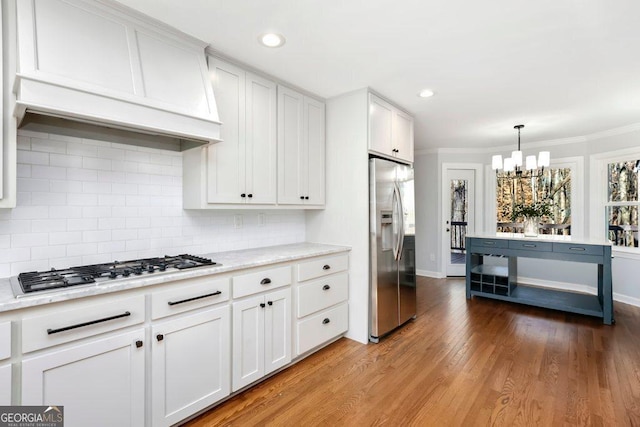 kitchen with premium range hood, appliances with stainless steel finishes, light hardwood / wood-style flooring, and white cabinets