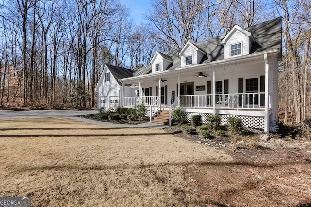 cape cod home featuring a porch, a front yard, and ceiling fan