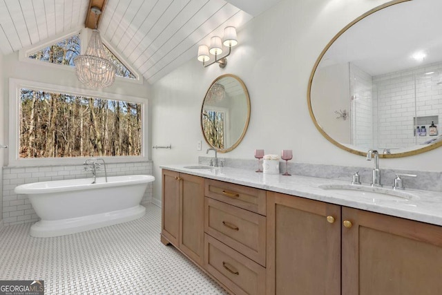 bathroom featuring vanity, a bath, tile patterned flooring, and lofted ceiling with beams