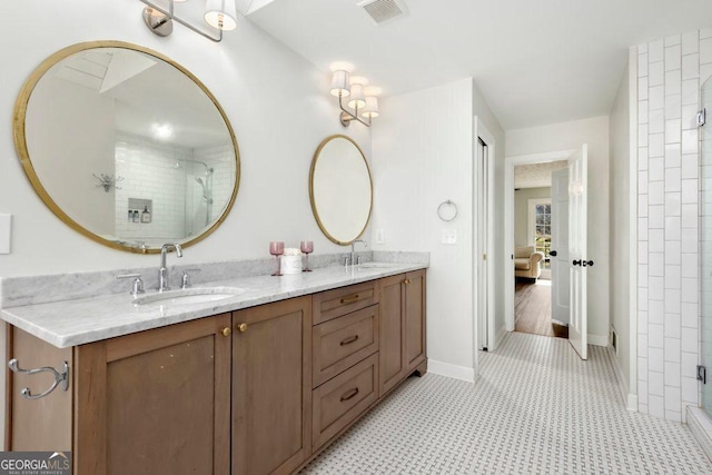 bathroom with vanity and a shower with door