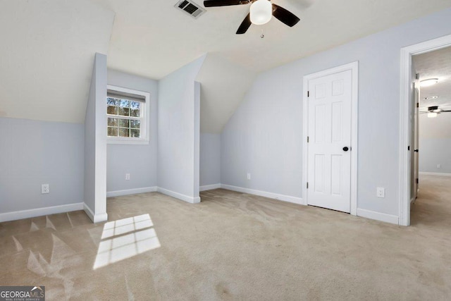 bonus room with vaulted ceiling, light carpet, and ceiling fan