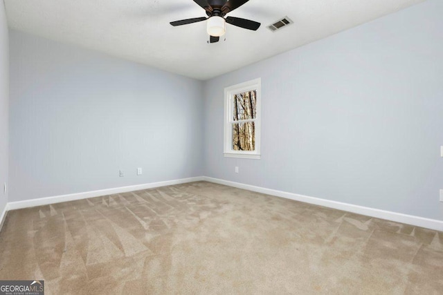 carpeted empty room featuring ceiling fan