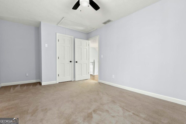 unfurnished bedroom featuring light colored carpet, a closet, and ceiling fan