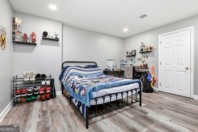 bedroom with hardwood / wood-style floors