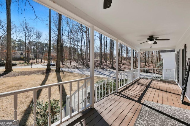 deck with ceiling fan and covered porch