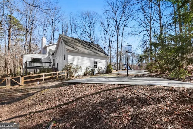 view of side of property featuring a wooden deck