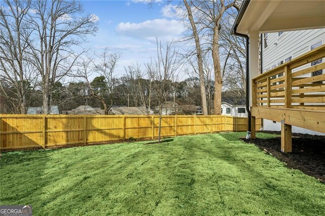 back of house featuring a wooden deck, a yard, and ceiling fan