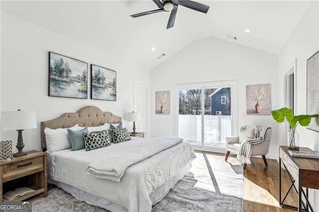 bedroom with access to outside, light hardwood / wood-style floors, ceiling fan, and vaulted ceiling