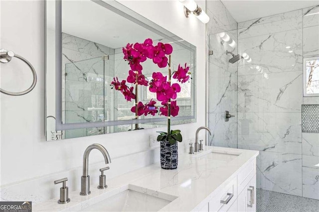 bathroom featuring a shower with door and vanity