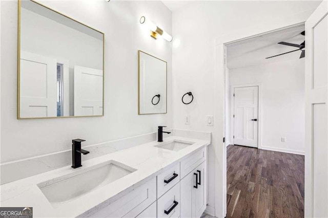 bathroom featuring ceiling fan, vanity, and wood-type flooring