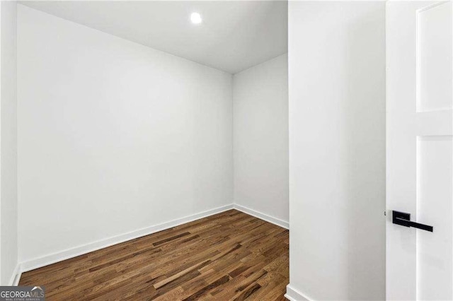 spare room with dark hardwood / wood-style flooring