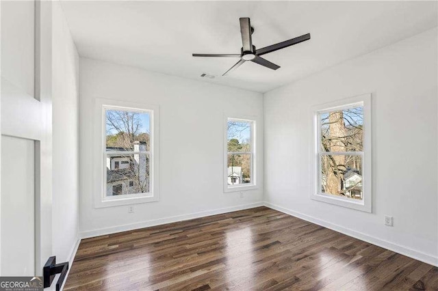 unfurnished room with dark wood-type flooring and ceiling fan