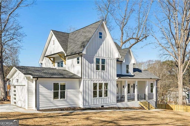 view of front of property featuring a garage, covered porch, and a front lawn