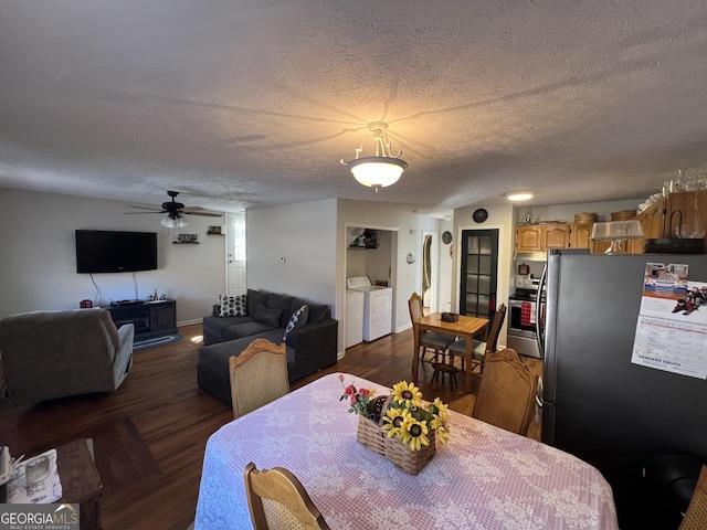 dining area featuring washing machine and dryer, dark wood-type flooring, ceiling fan, and a textured ceiling