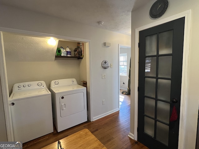 clothes washing area featuring dark hardwood / wood-style floors, washer and dryer, and a textured ceiling