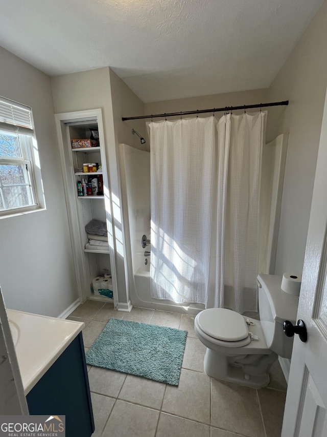 full bathroom featuring shower / tub combo, vanity, a textured ceiling, tile patterned floors, and toilet