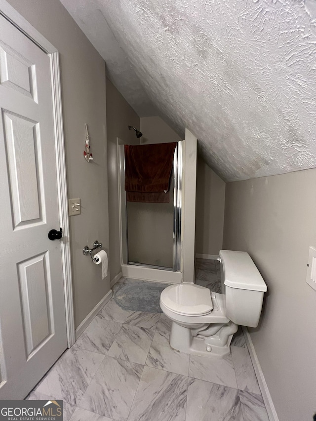 bathroom featuring toilet, lofted ceiling, a textured ceiling, and walk in shower