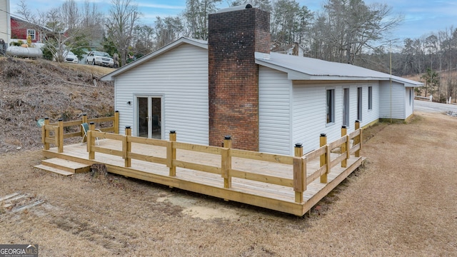 rear view of property featuring a wooden deck