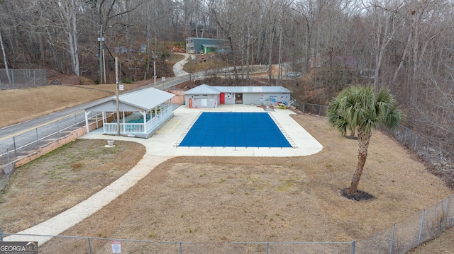 view of swimming pool featuring a yard and a patio