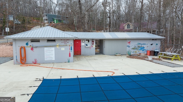 exterior space with a covered pool